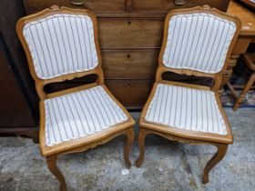 A pair of 20th century French style beech framed chairs Location: