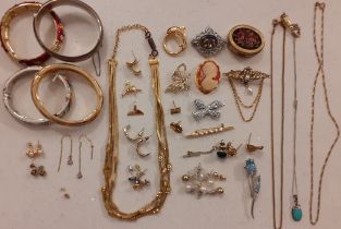 A quantity of costume jewellery to include an engraved silver bangle stamped with the makers mark JS