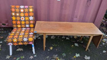 A mid 20th century Nathan teak coffee table having a fall flap, 45.5cm h x 122cm w and a retro chair