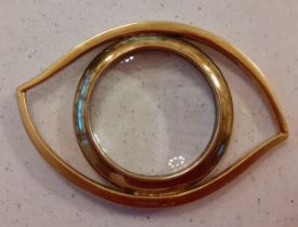 Hermes- A 1980's gilt metal magnifying glass fashioned as an eye with convex lens, stamped Hermes,