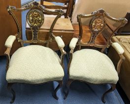 A pair of late Victorian mahogany and marquetry inlaid salon armchairs on carbide legs Location: