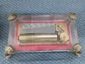 A mid 20th Century Reuge, Saint -Croix music box in glazed case with 4 metal feet in the form of