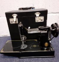 A Singer 221K portable electric sewing machine serial no:EG964223 with manual, accessories and black