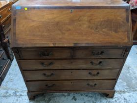 A Georgian mahogany cross banded bureau, fall flap with fitted pigeonhole and drawer interior, above