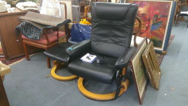 A Restwell Roma reclining heated and vibrating massage black faux leather armchair and stool