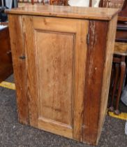 A 19th century pine side cabinet having a single door and on a plinth base, 92cm h x 69.5cm w