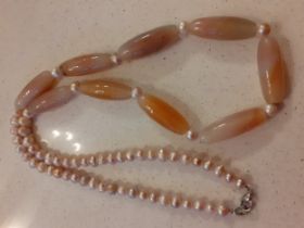 Bvlgari-A vintage necklace having pink simulated pearls and 9 pink and peach hue agate cylindrical