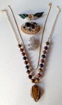 A small quantity of costume jewellery to include a tigers eye necklace on gold tone chain, a
