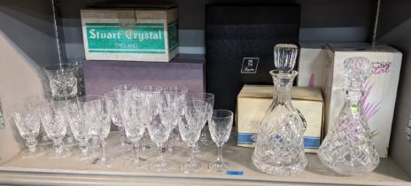 Glassware to include a Waterford decanter, a set of eight wine glasses, Stuart glasses and others