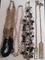 A quantity of vintage fashion jewellery to include an Aurora Borealis necklace, 2 silver ingots on