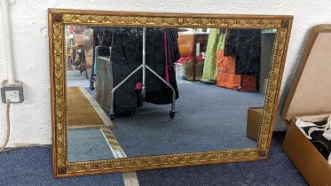 An early 20th century mirror having a gilt highlighted and floral moulded border, 69cm h x 99.5cm