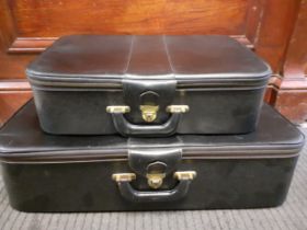 Two vintage Victor black leather suitcases with red silk lining, one 27" wide and the other 21"