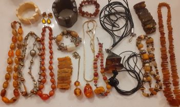 Late 20th Century costume jewellery to include an amber rough cut necklace and 2 amber bracelets