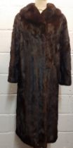 A late 20th Century dark brown (almost black to the eye) mink coat having a shawl collar and a brown