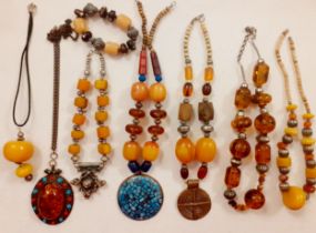 Vintage Worldwide costume necklaces and bracelet to include a Moroccan silver tone and amber bead