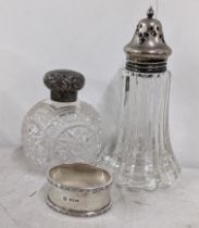 An early 20th century silver napkin ring together with a silver topped dressing table jar and a