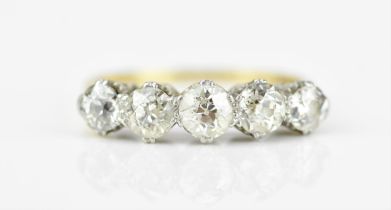 An 18ct gold and five stone diamond ring, set with old cut diamonds in double claw setting, the