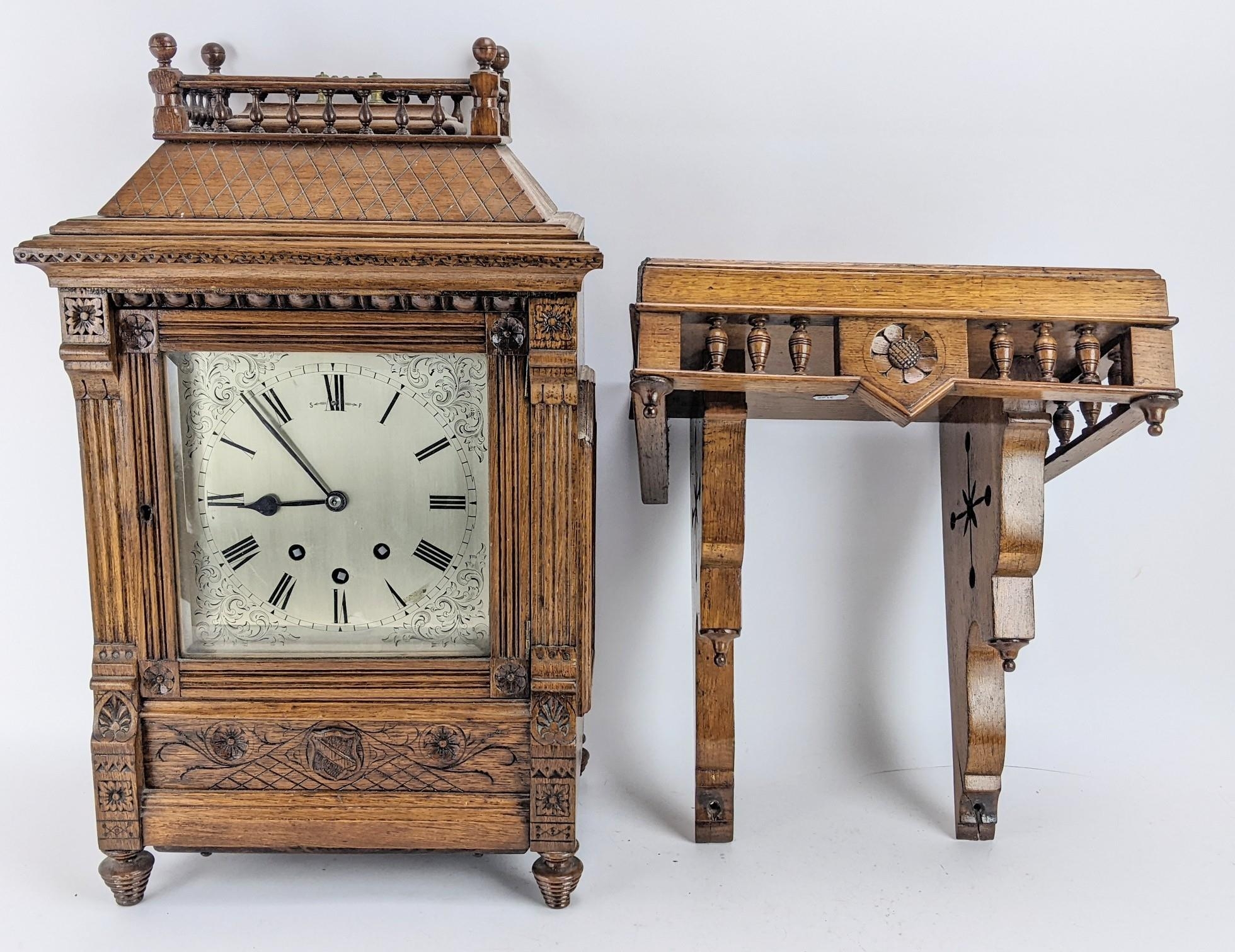 A late 19th century oak bracket clock, the case of architectural design having a handle to the top