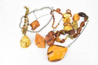 A collection of raw and polished baltic amber jewellery, comprising large pendants, bracelets and