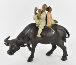 A 20th century Chinese shiwan glazed pottery model of by Liu Zemian, modelled as a couple on the