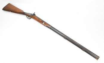 A percussion single barrel rifle, with walnut stock, steel trigger guard, and metal ramrod with