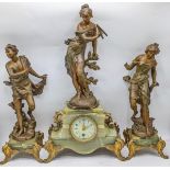 A late 19th century French clock with matching garnitures, the onyx and gilt case having gilt