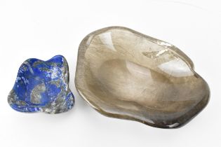 A rutilated quartz freeform bowl, together with a smaller freeform polished lapis lazuli bowl, the