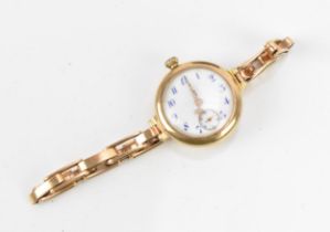 An early 20th century, manual wind, ladies 14ct gold wristwatch, having a white enamel dial with