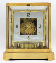 A Jaeger Le Coultre Atmos clock circa 1960s, in a gilt brass case, having a square cream chapter