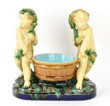 A late 19th century Minton majolica centrepiece, circa 1858, modelled as two dyonisian cherubs