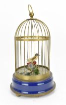 A 20th Century singing bird cage automaton, with fabric flowers and feather model of a bird,