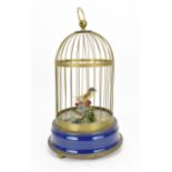 A 20th Century singing bird cage automaton, with fabric flowers and feather model of a bird,