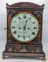 A William IV mahogany 8 day mantle clock, the case having pierced grille sides, floral swag