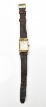 An Omega, manual wind, gents, 14ct gold wristwatch, circa 1940s, having a silvered dial,