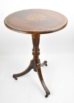 An Edwardian rosewood inlaid tripod table, the circular top with foliate inlaid roundel, resting