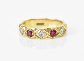 A yellow gold, ruby and diamond ring, set with three brilliant cut diamonds and two rubies, on a