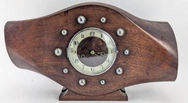 An early/mid 20th century mahogany propeller boss mantle clock, the 6 inch dial having a chrome