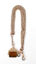 A 9ct gold curb link pocket watch chain having two dog clip clasps and a 9ct gold swivel fob seal,