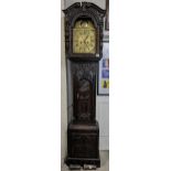 An 18th century and later longcase clock, the heavily carved oak case having broken swan neck