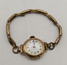 A 9ct gold manual wind wristwatch on a gold plated bracelet Location: