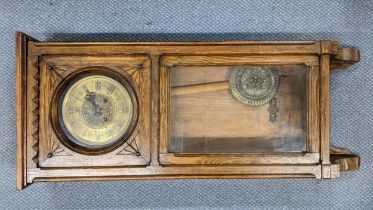 An early 20th century oak cased 8-day wall hanging clock striking on a gong, 93.5cm h x 39cm w