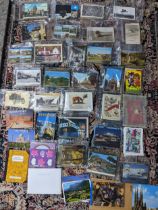 A quantity of various postcards Location: