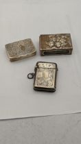 A silver embossed trinket, along with a silver vesta case and one other 44.7g Location: