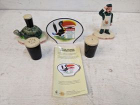 Guinness advertising ceramics to include two Carlton ware figures, a Royal Doulton name stand and