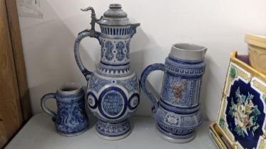 Three German salt glazed tankards to include one having a peter lid Location: