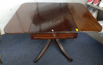 An early 20th century mahogany drop leaf table having a single drawer and a pedestal base