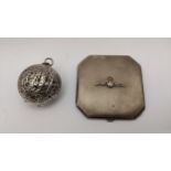 A 19th century silver walnut shaped pendant, together with a silver plated RAF compact Location: