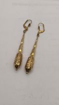 A pair of gold plated drop earrings having an engraved detail to the bottom Location: