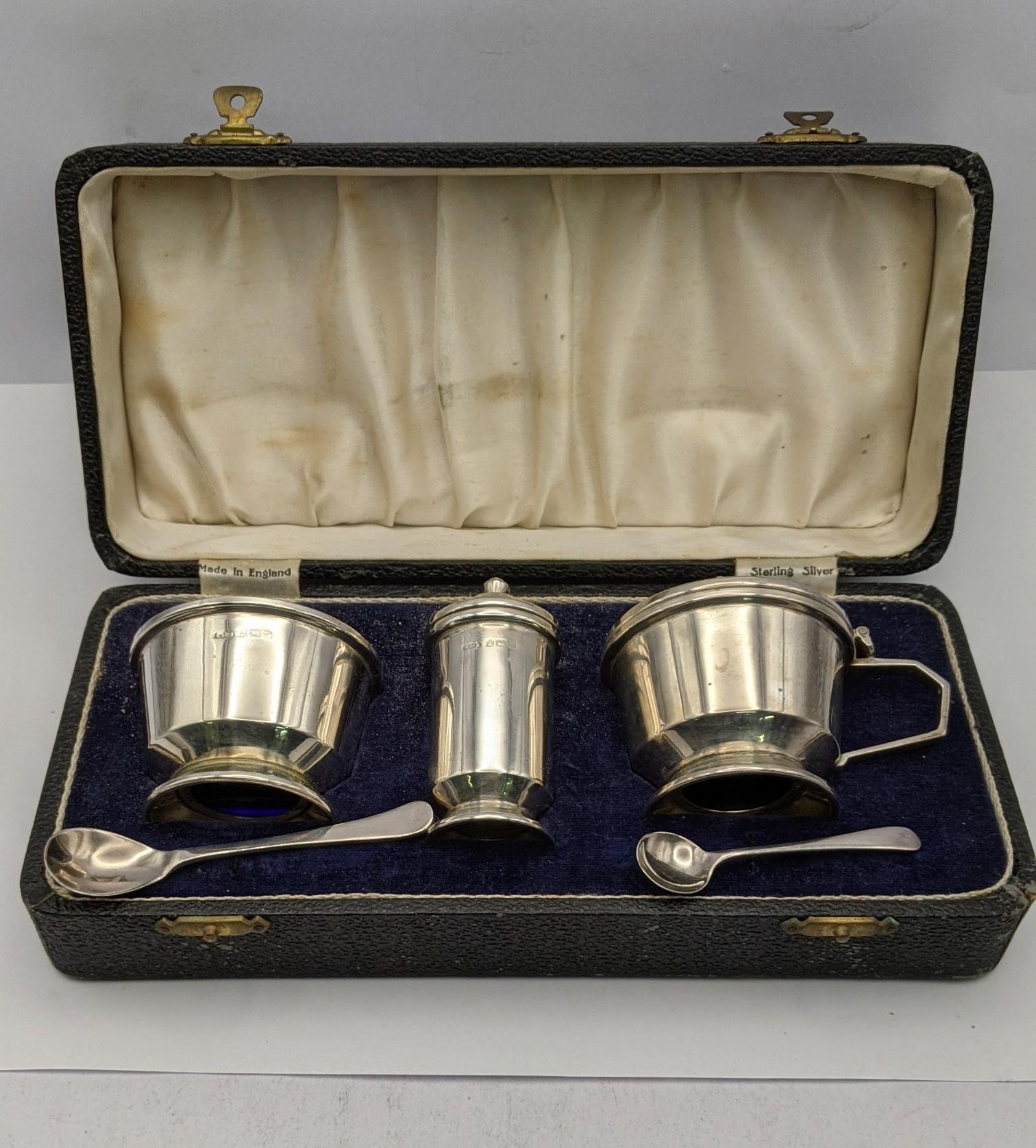 A silver condiment set hallmarked Birmingham 1948, 162g excluding glass Location: