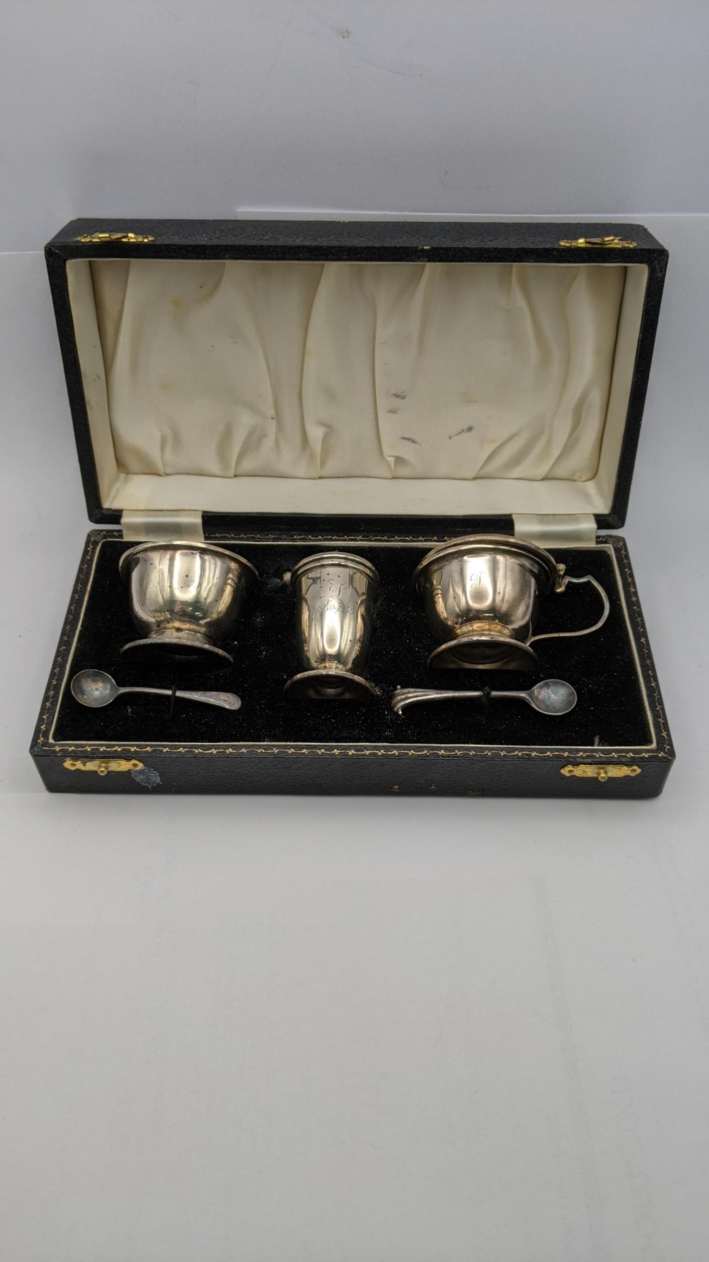 A silver condiment set hallmarked Birmingham 1953 to include a silver salt, mustard pot A/F, and